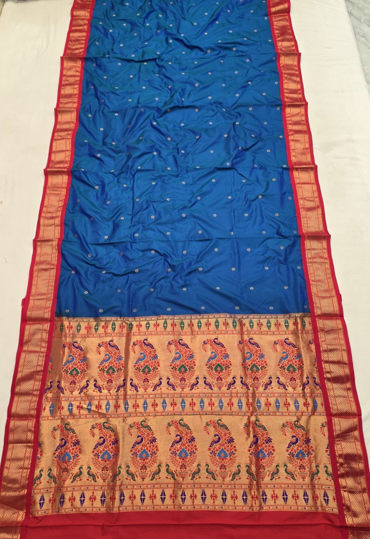 Royal Blue 9 yard silk Paithani Nauvari saree with red border, shoulder butta and peacock pallu