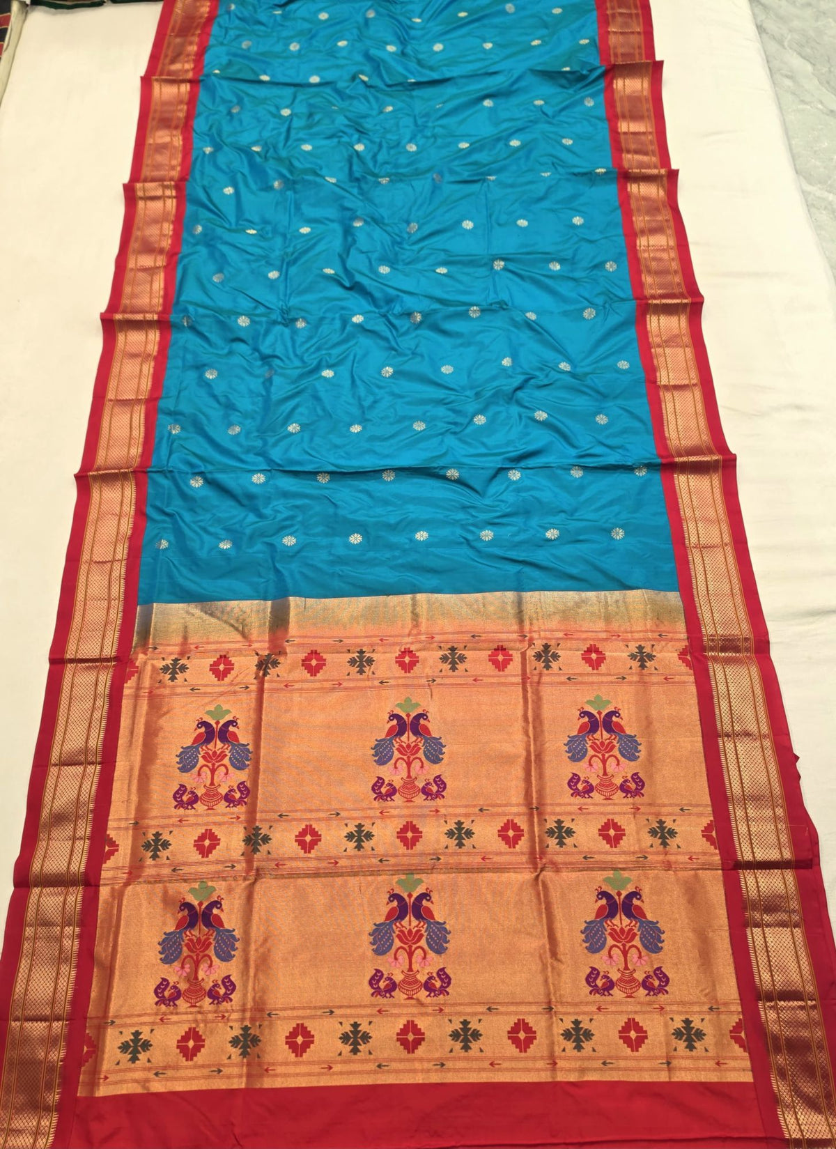 Turquoise 9 yard silk Paithani Nauvari saree with red border, shoulder butta and peacock pallu