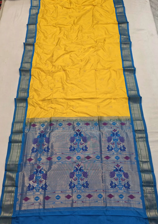 Yellow 9 yard silk Paithani Nauvari saree with blue border, shoulder butta and peacock pallu