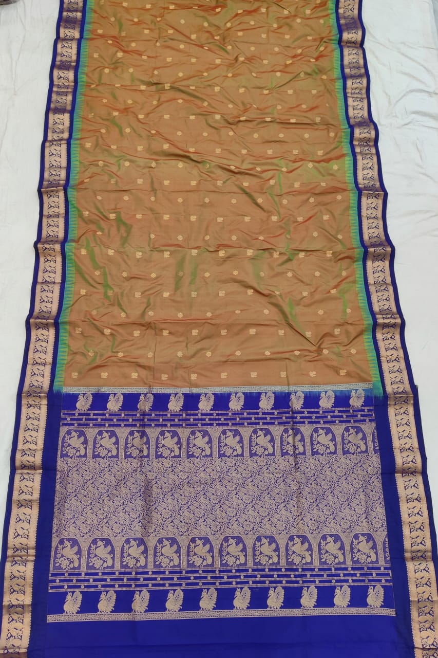 Copper Brown silk Gadwal saree with royal blue border, peacock pallu and all-over butta