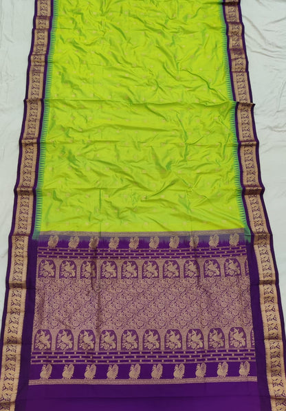 Lime Green silk Gadwal saree with purple border, peacock pallu and all-over butta