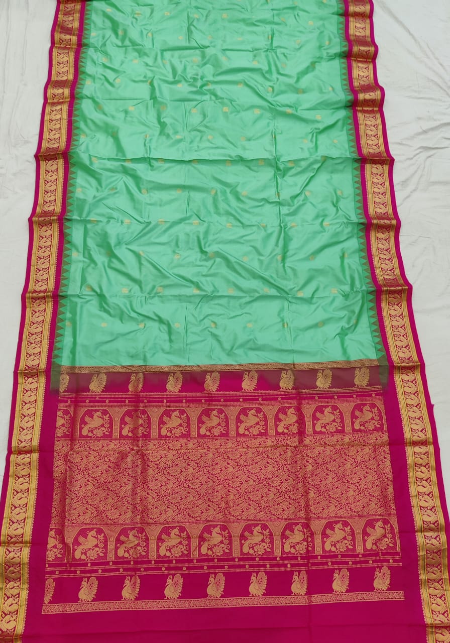 Mint Green silk Gadwal saree with rani pink border, peacock pallu and all-over butta