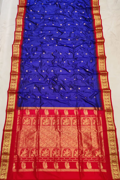 Royal Blue silk Gadwal saree with red border, peacock pallu and all-over butta