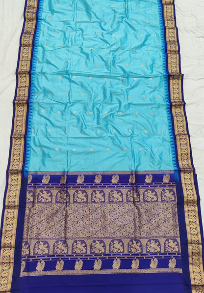 Sky Blue silk Gadwal saree with navy blue border, peacock pallu and all-over butta